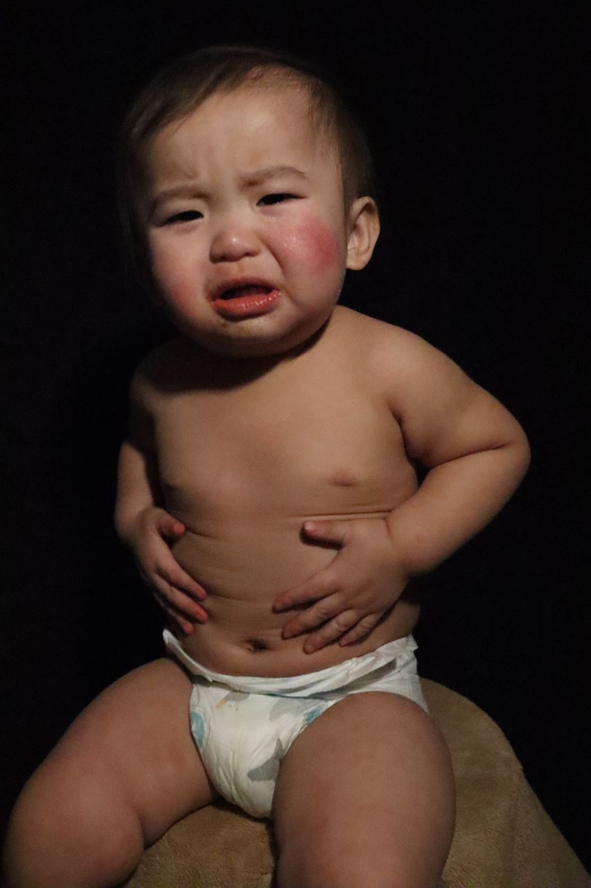Studio portrait of grimacing baby in diaper. Lisa Xiong, “A Child's Beauty part 3,” photograph, 14”x20”